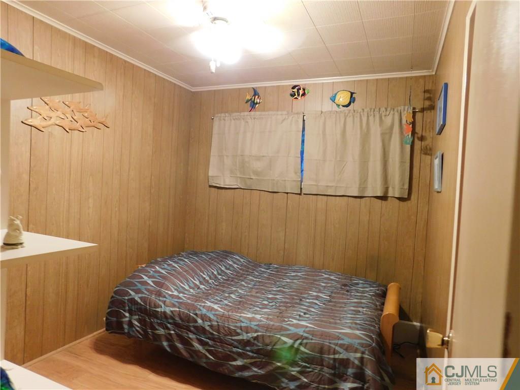 19 Raleigh Road Edison, NJ 08817 - Photo 14 of 19 a bedroom with a bed and a mirror
