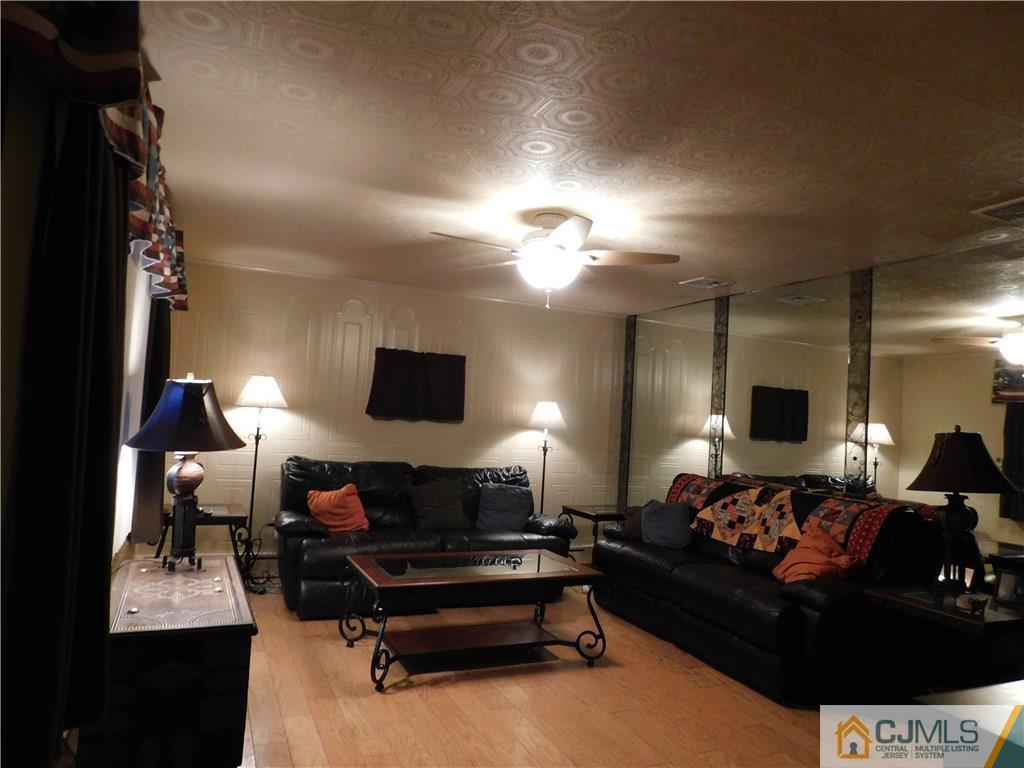 19 Raleigh Road Edison, NJ 08817 - Photo 8 of 19 a living room with furniture and a flat screen tv