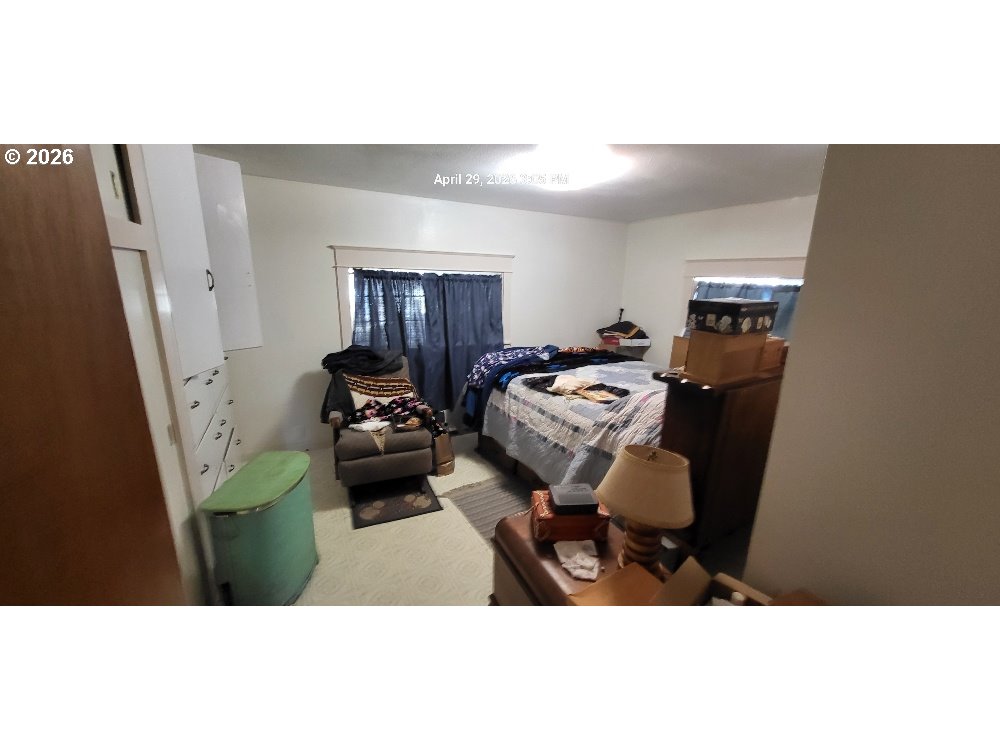 1439 Union Avenue North Bend, OR 97459 - Photo 11 of 23 a living room with furniture and a baby crib