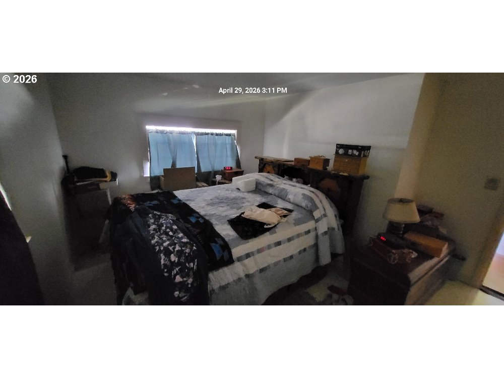 1439 Union Avenue North Bend, OR 97459 - Photo 12 of 23 a bed room with a bed window and a mirror