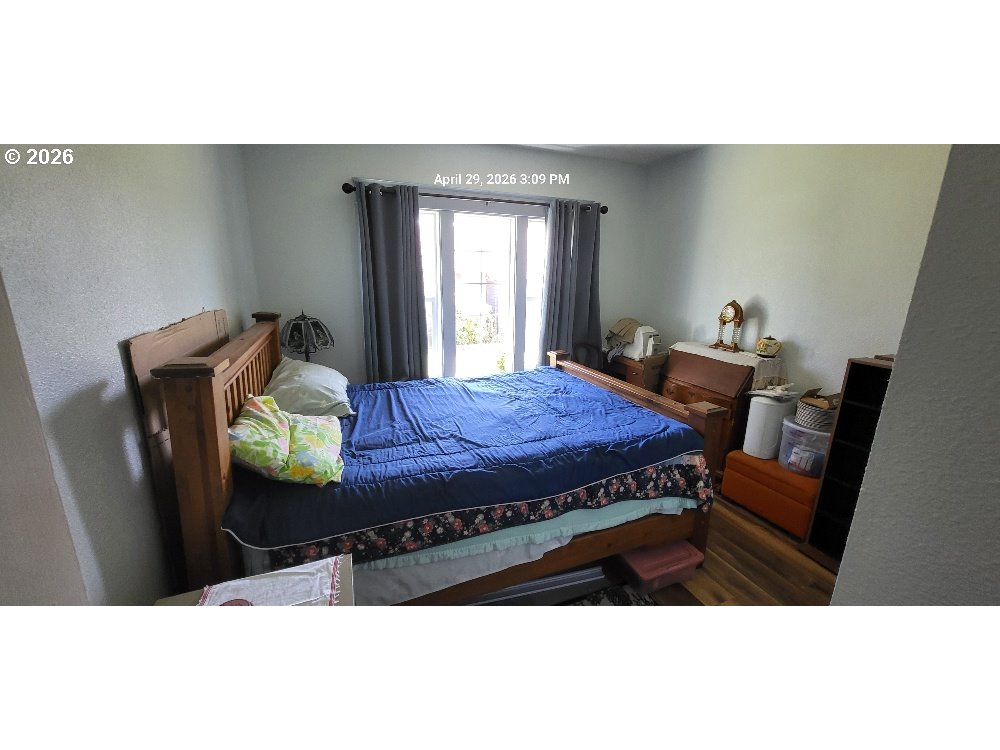 1439 Union Avenue North Bend, OR 97459 - Photo 13 of 23 a view of a bedroom with furniture and window