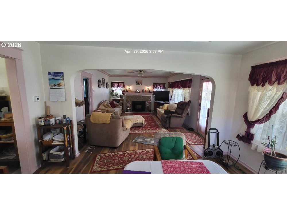 1439 Union Avenue North Bend, OR 97459 - Photo 22 of 23 a living room with furniture a rug and gym equipment