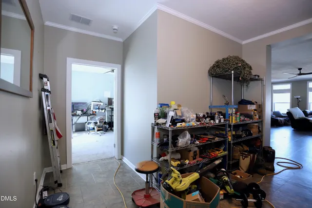 a view of a workspace with furniture and a window