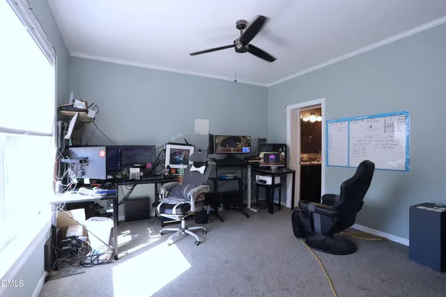 a view of a workspace with furniture and a window