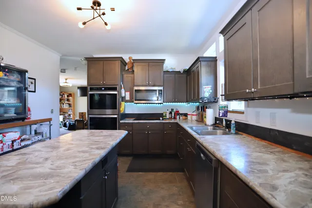 a kitchen with stainless steel appliances granite countertop a sink counter space cabinets and a counter top space