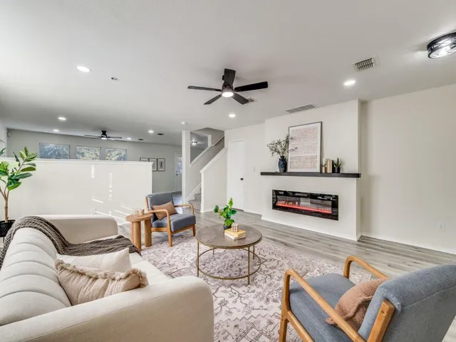 a living room with furniture and a wooden floor