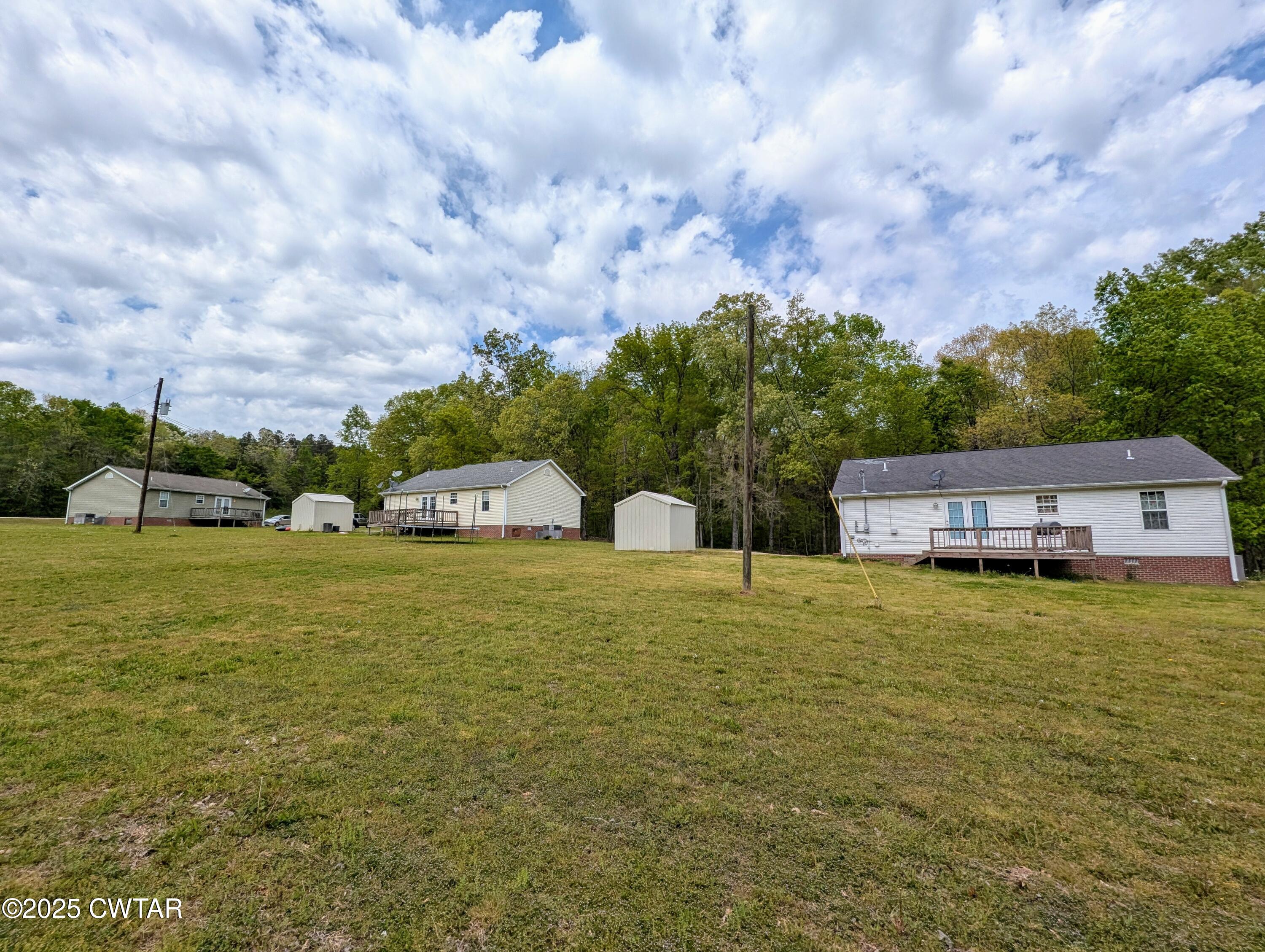 1600 Meeks Loop Adamsville, TN 38310 - Photo 5 of 6 a house view with swimming pool and green space