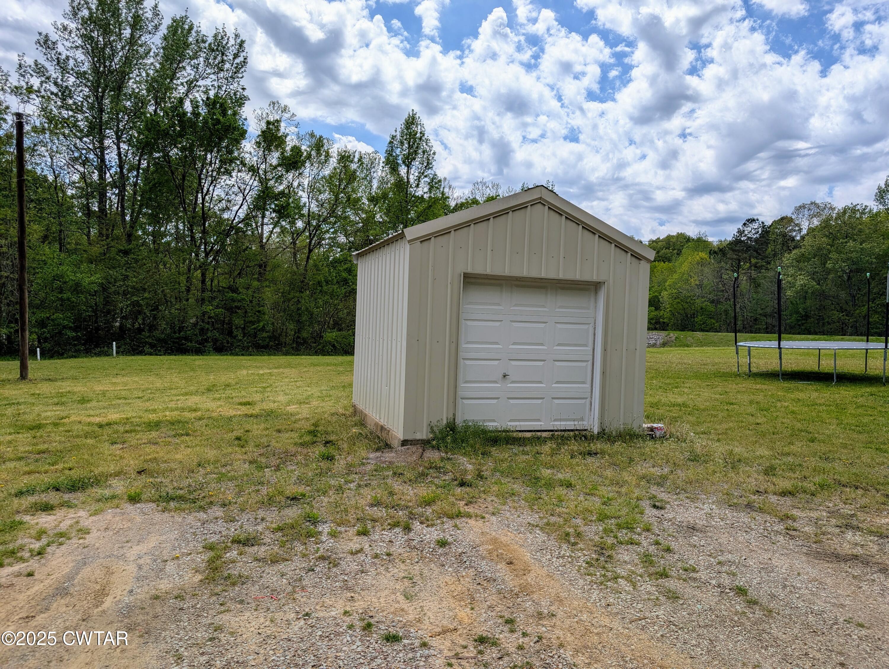1600 Meeks Loop Adamsville, TN 38310 - Photo 6 of 6 a house with green field in front of it