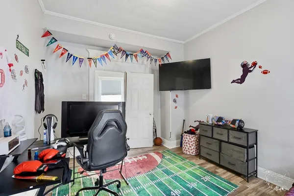 a bed room with a bed and a television