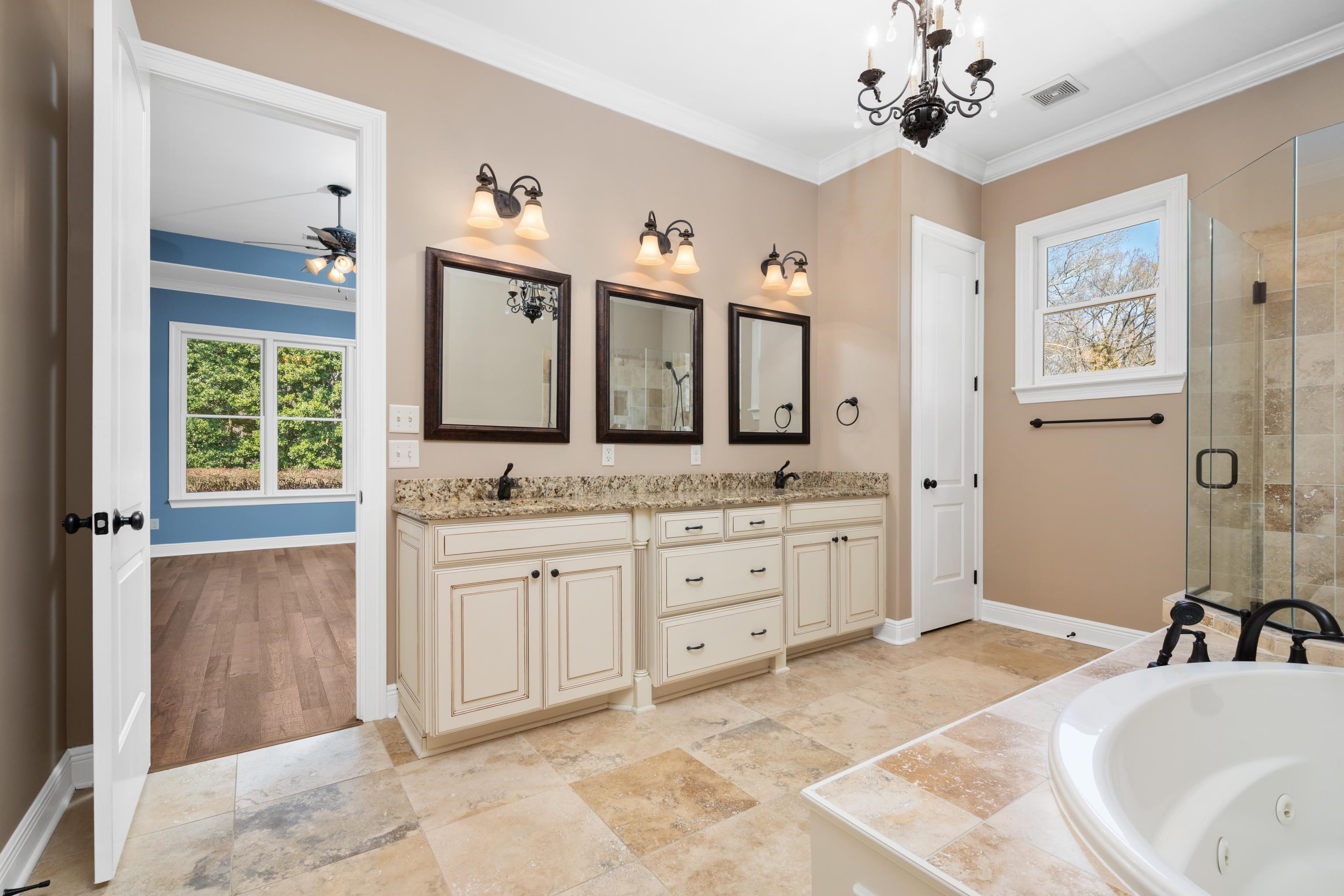 25 Riversedge Cove North Arlington, TN 38002 - Photo 3 of 40 a spacious bathroom with a granite countertop sink mirror and bathtub