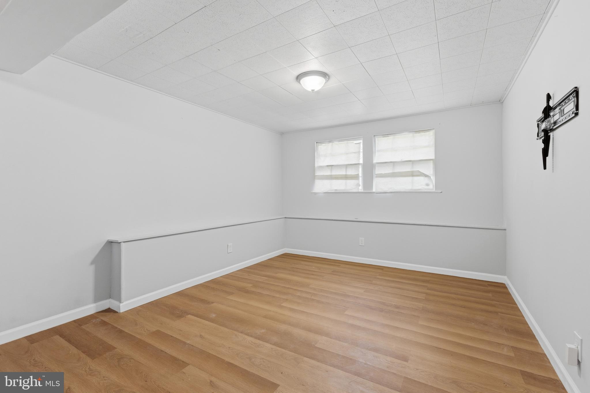 119 Jefferson Road Waldorf, MD 20602 - Photo 26 of 40 an empty room with wooden floor and windows
