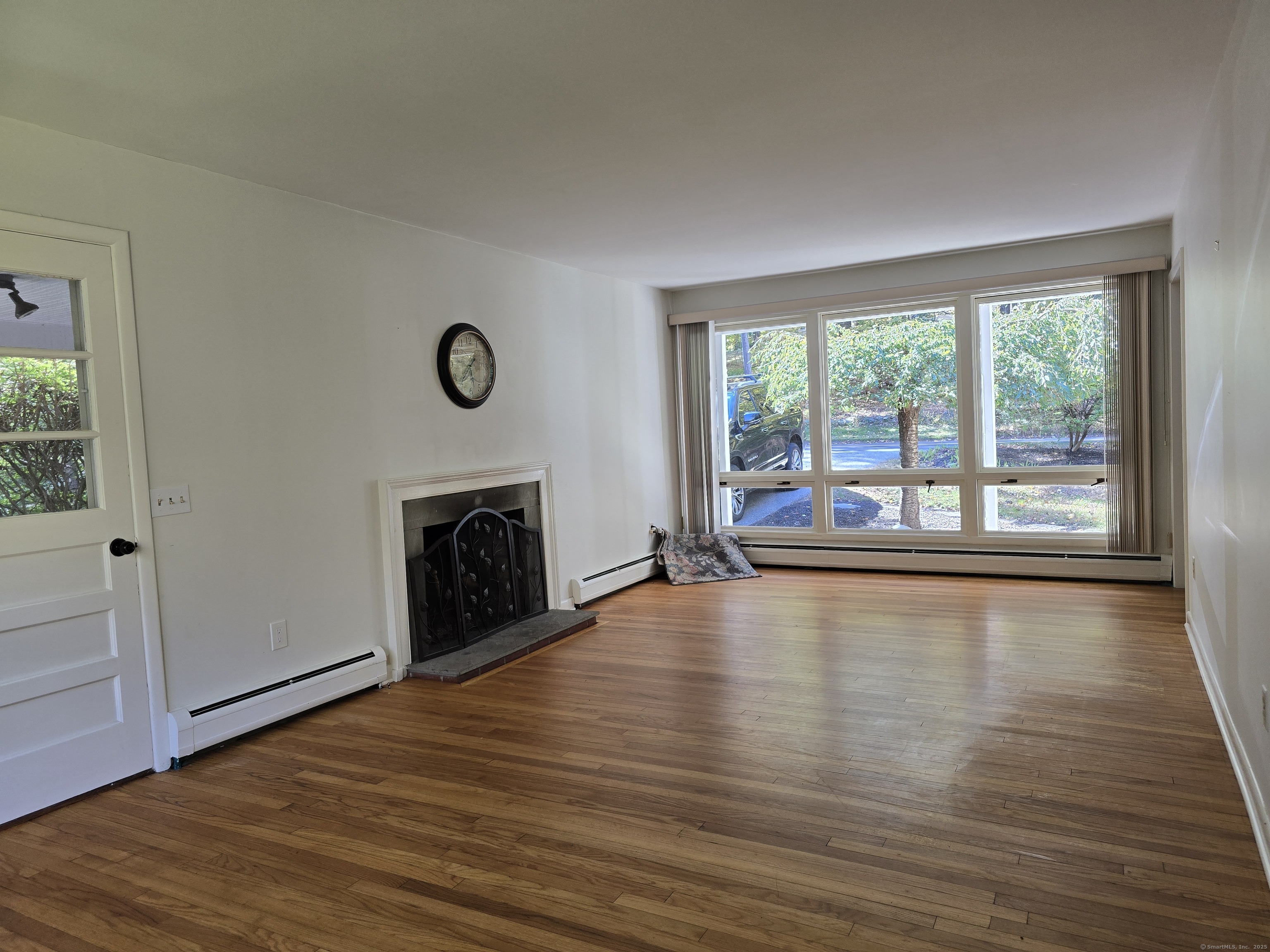 32 Old Green Road Newtown, CT 06482 - Photo 11 of 29 a view of empty room with wooden floor and fireplace