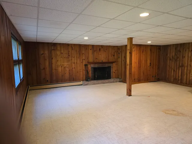 an empty room with furniture window and fireplace