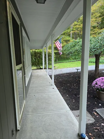 a view of a porch with wooden floor and outdoor space