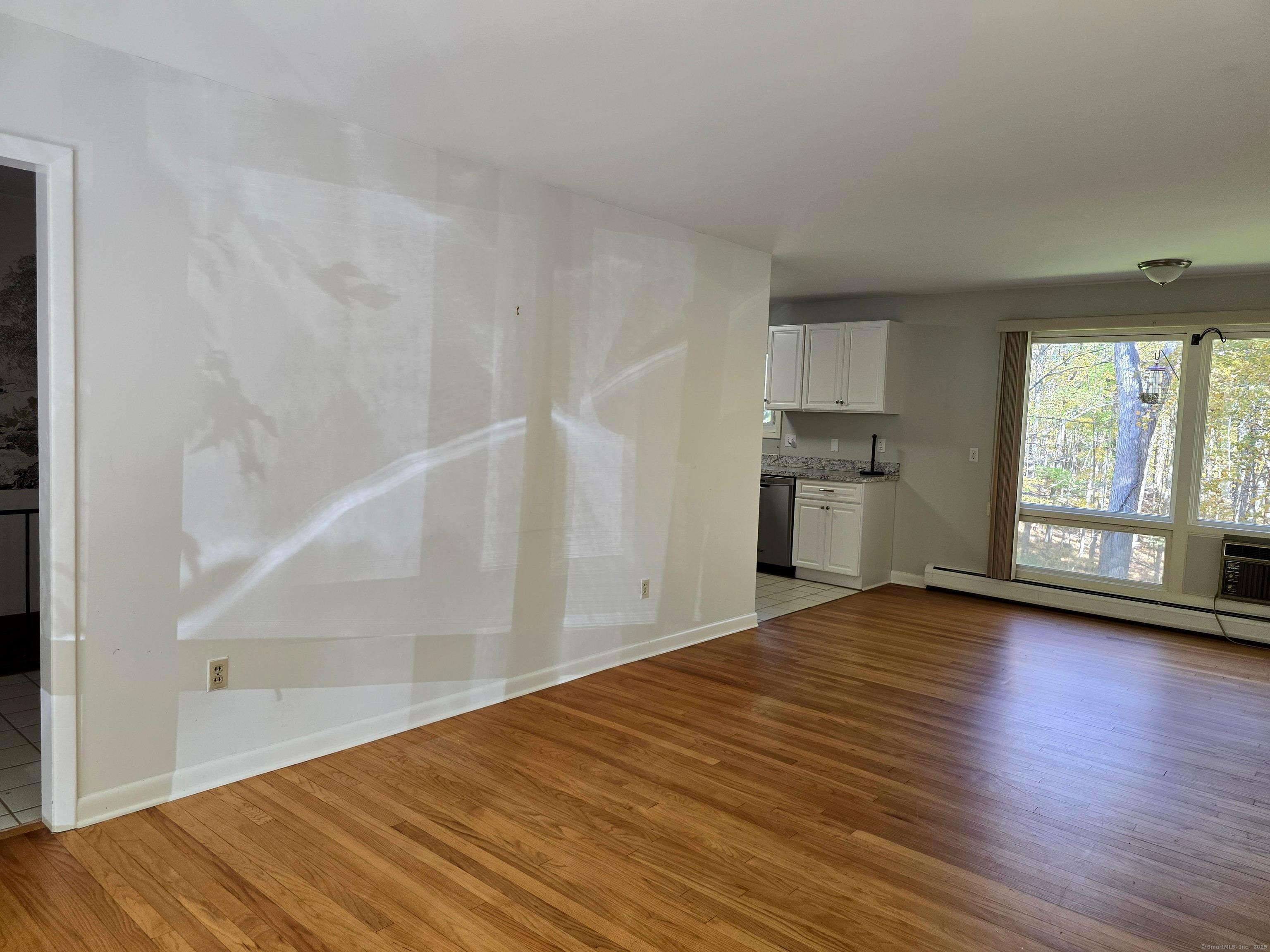 32 Old Green Road Newtown, CT 06482 - Photo 7 of 29 a view of empty room with wooden floor and fan