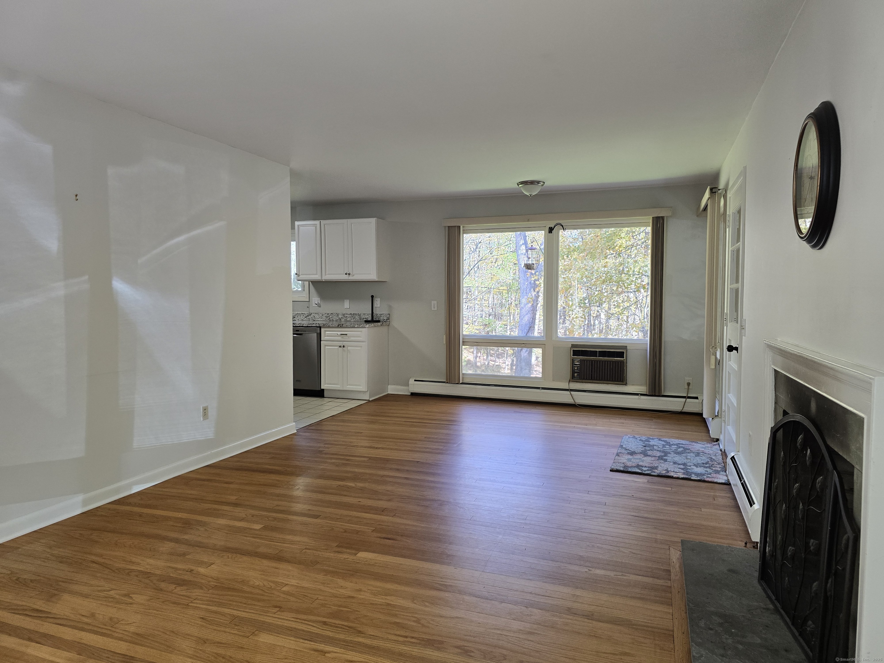 32 Old Green Road Newtown, CT 06482 - Photo 9 of 29 a view of empty room with a fireplace and wooden floor