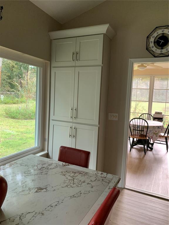 11636 Southwest 75th Circle Ocala, FL 34476 - Photo 11 of 38 a bedroom with a bed and large windows