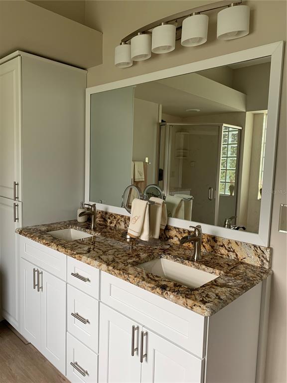 11636 Southwest 75th Circle Ocala, FL 34476 - Photo 16 of 38 a bathroom with a granite countertop sink and a mirror