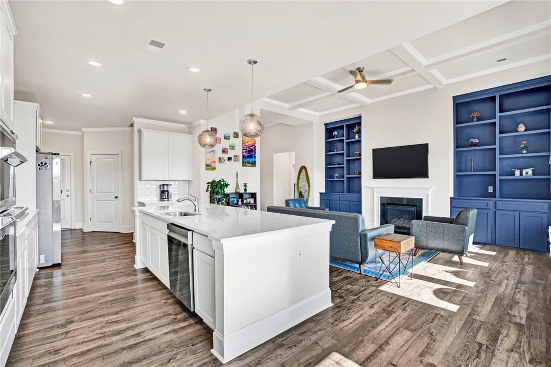 142 Juniper Hill Drive Easley, SC 29642 - Photo 16 of 47 An inviting open concept living space features a functional kitchen island and built-in shelving.