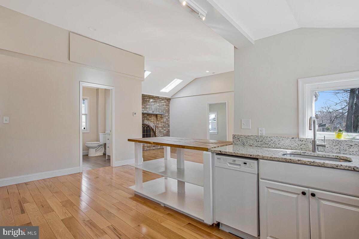 1916 Ridgeville Road Edgewater, MD 21037 - Photo 2 of 27 a large white kitchen with a sink and dishwasher refrigerator stove with wooden floor