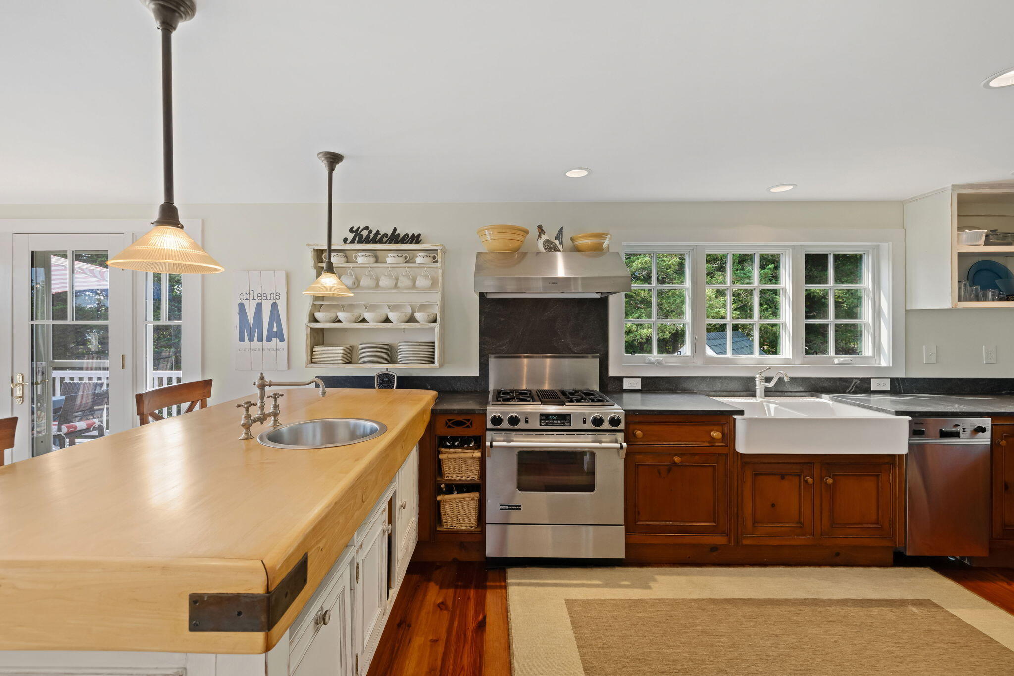 63 Briar Spring Road Orleans, MA 02653 - Photo 12 of 37 a kitchen with stainless steel appliances a stove a sink a counter top space and living room view