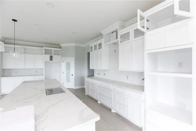 a large white kitchen with white cabinets and white appliances