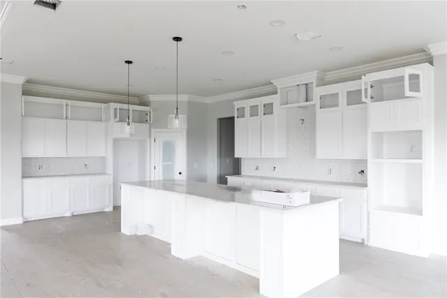 a kitchen with kitchen island white cabinets and white appliances
