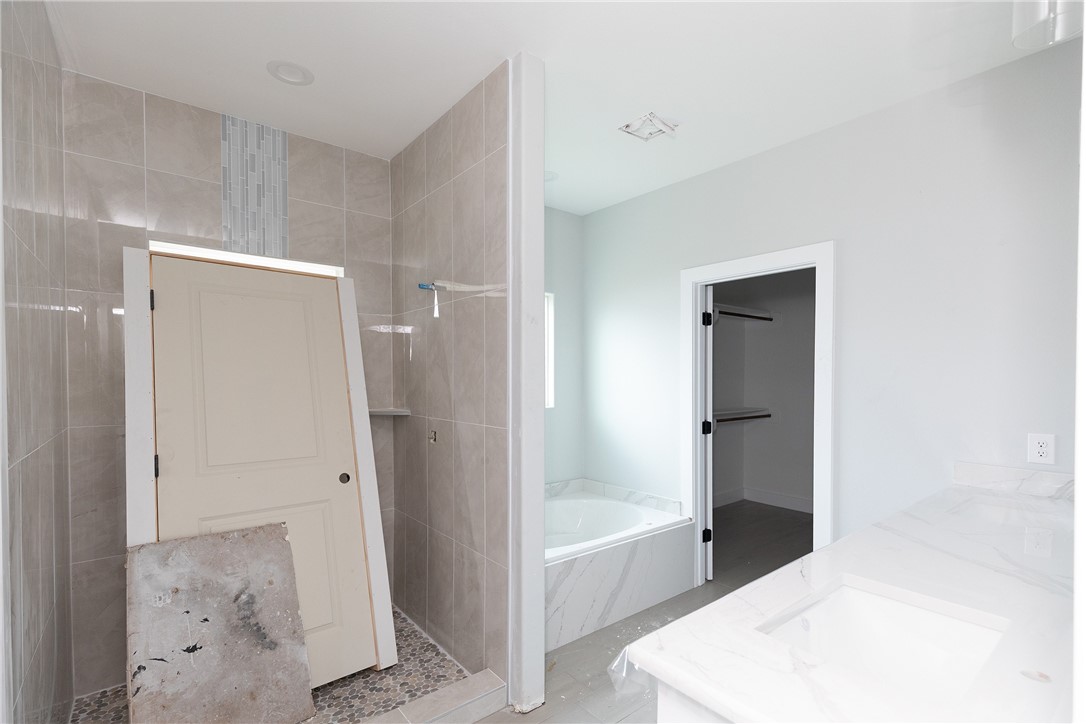 702 Mama Fefi Drive Corpus Christi, TX 78414 - Photo 9 of 10 a bathroom with a tub shower and closet