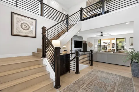 a living room with furniture and a view of kitchen