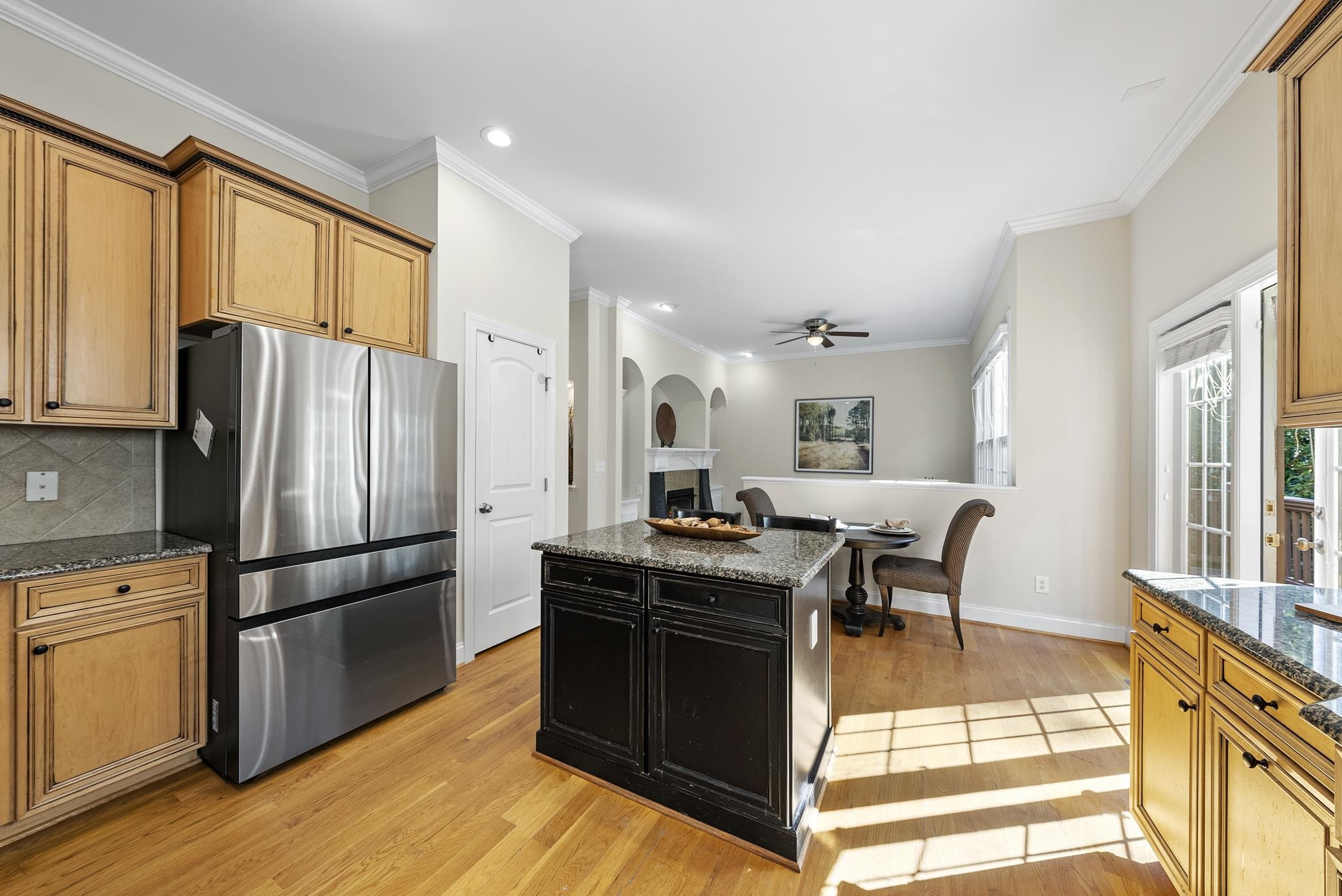 7357 Newport Avenue Raleigh, NC 27613 - Photo 11 of 44 a kitchen with stainless steel appliances granite countertop a table chairs and a refrigerator