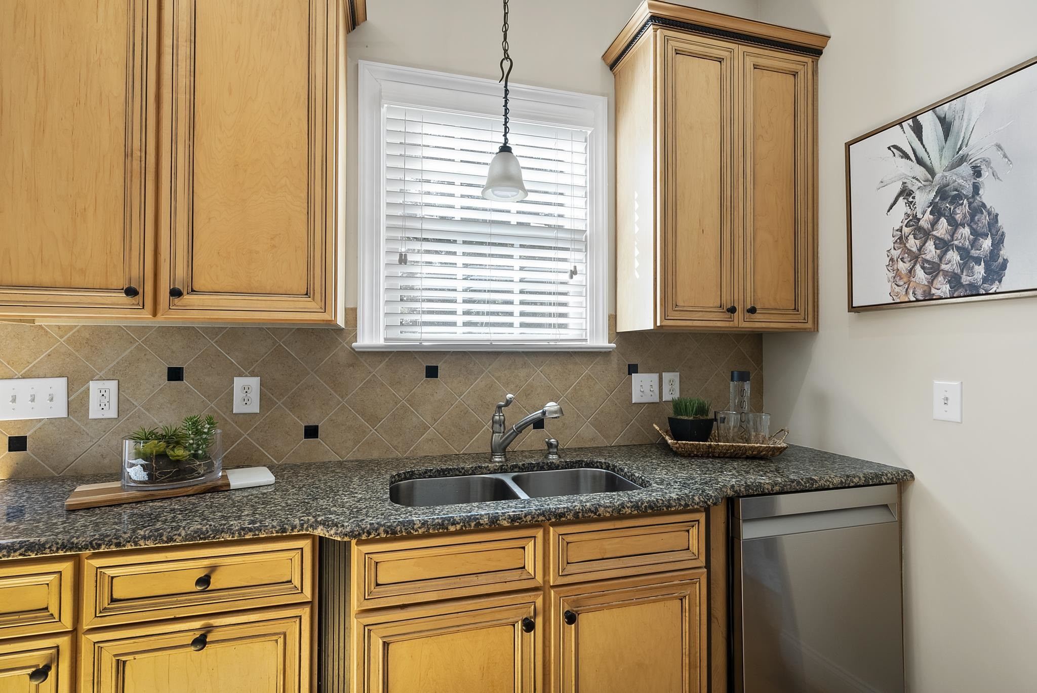 7357 Newport Avenue Raleigh, NC 27613 - Photo 13 of 44 a kitchen with granite countertop white cabinets and window