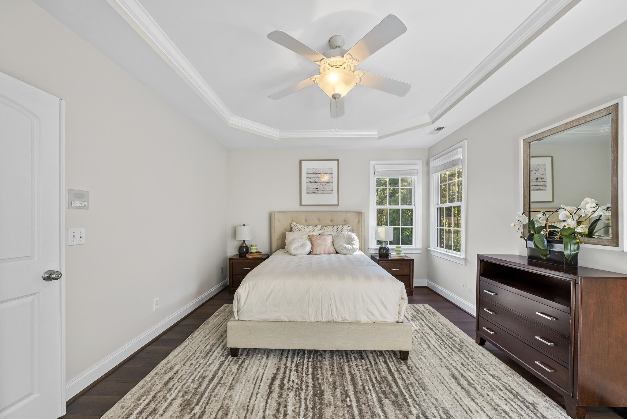 7357 Newport Avenue Raleigh, NC 27613 - Photo 17 of 44 a spacious bedroom with a bed and a chandelier