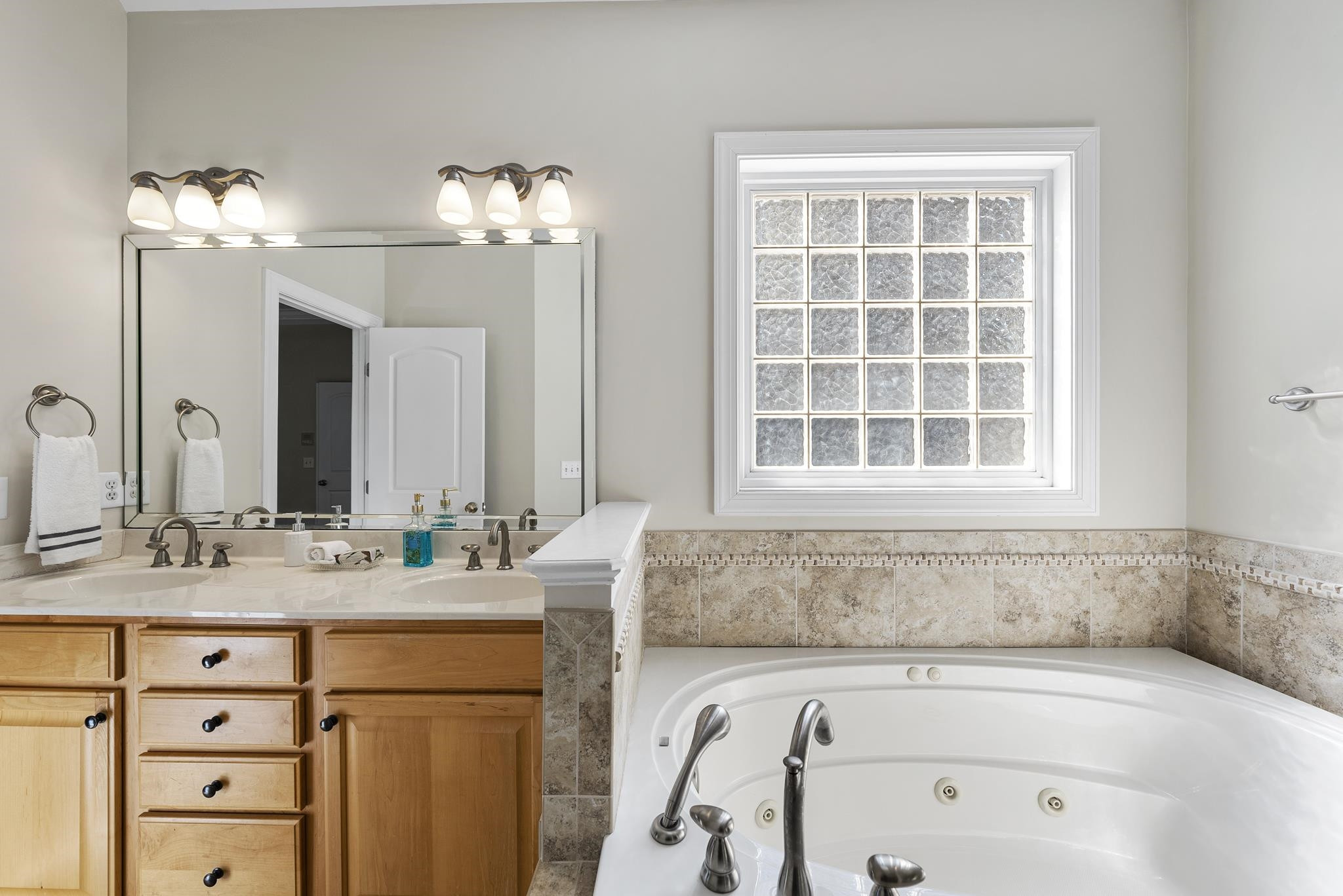 7357 Newport Avenue Raleigh, NC 27613 - Photo 19 of 44 a bathroom with a bathtub sink and mirror