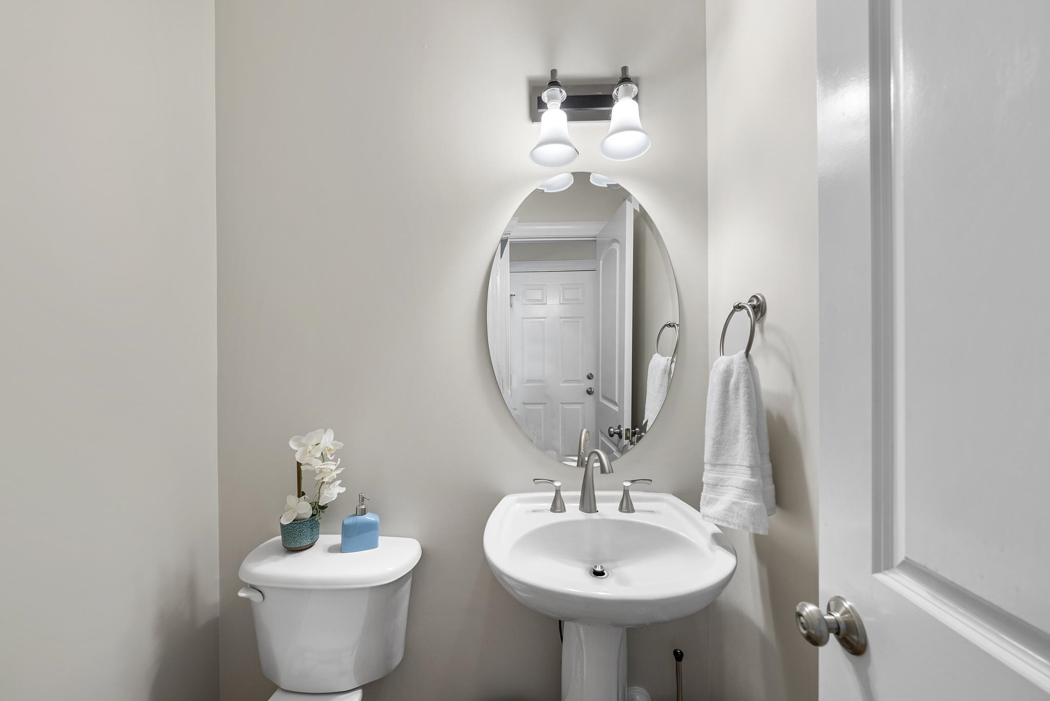 7357 Newport Avenue Raleigh, NC 27613 - Photo 28 of 44 a bathroom with a toilet sink and mirror