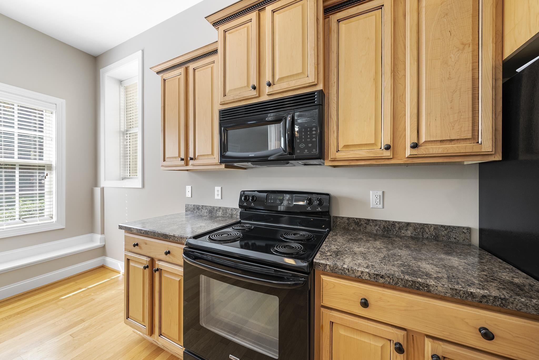 7357 Newport Avenue Raleigh, NC 27613 - Photo 30 of 44 a kitchen with granite countertop cabinets stainless steel appliances and a window