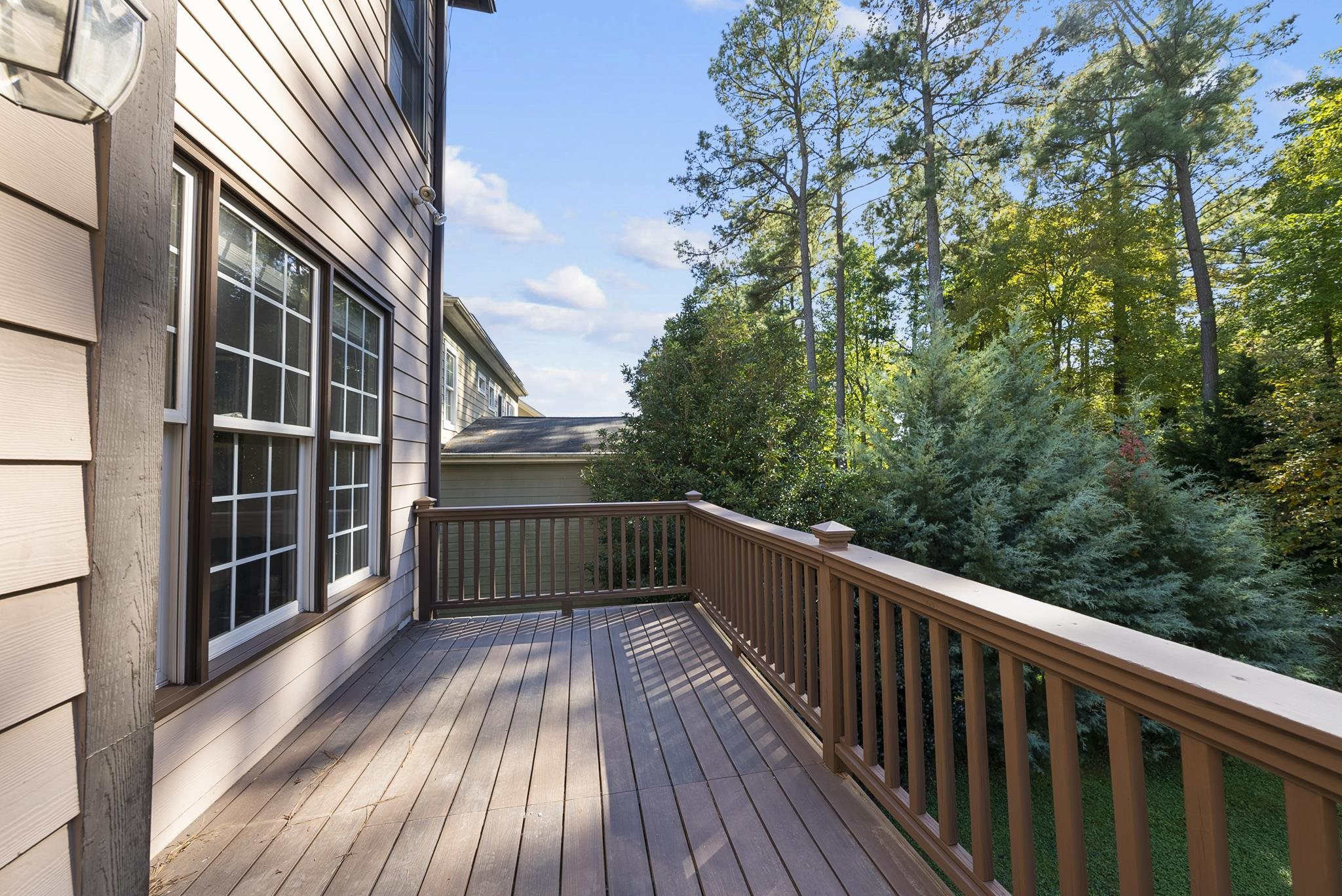 7357 Newport Avenue Raleigh, NC 27613 - Photo 40 of 44 a view of balcony with wooden floor and fence
