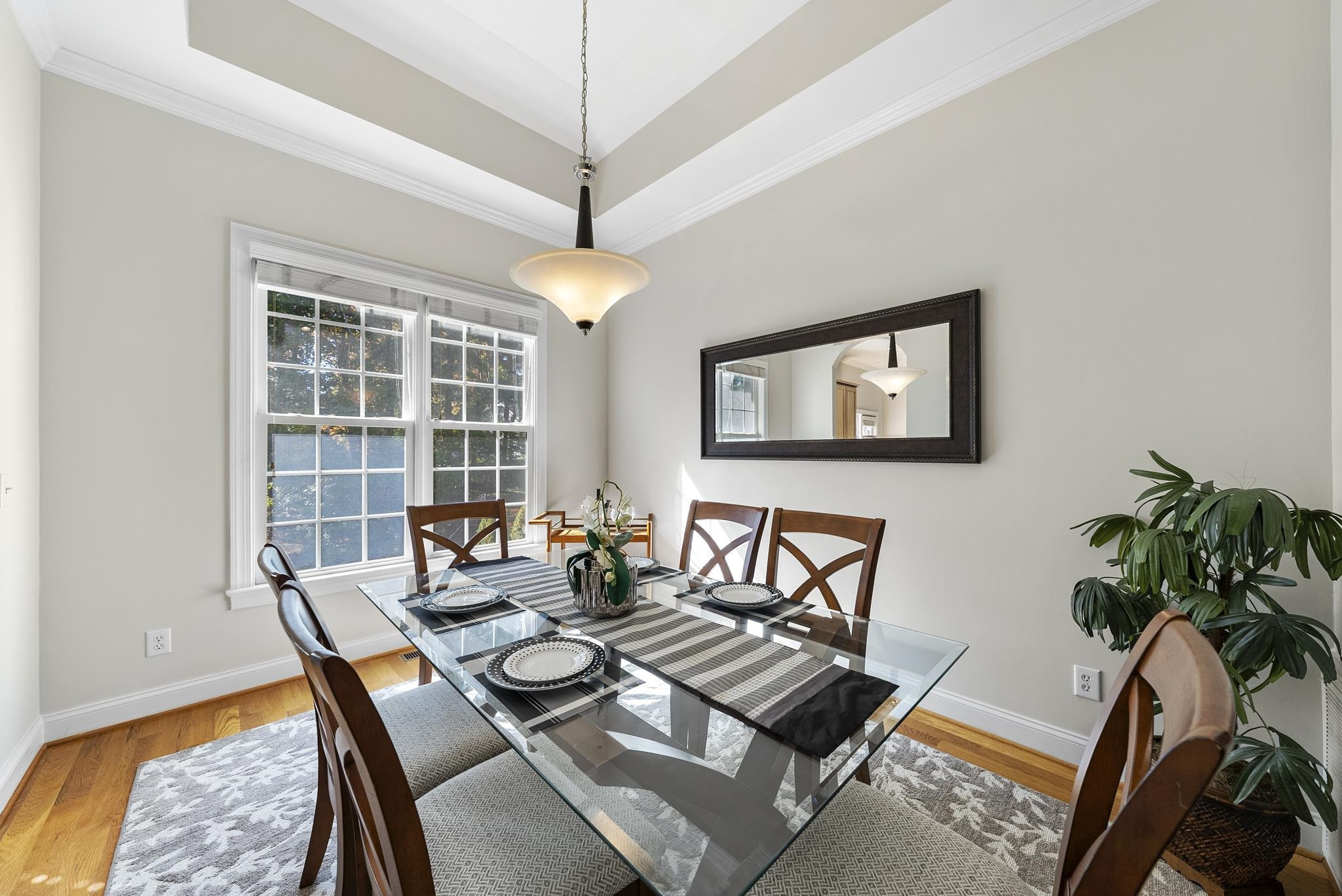 7357 Newport Avenue Raleigh, NC 27613 - Photo 7 of 44 a dining room with furniture a rug and a chandelier