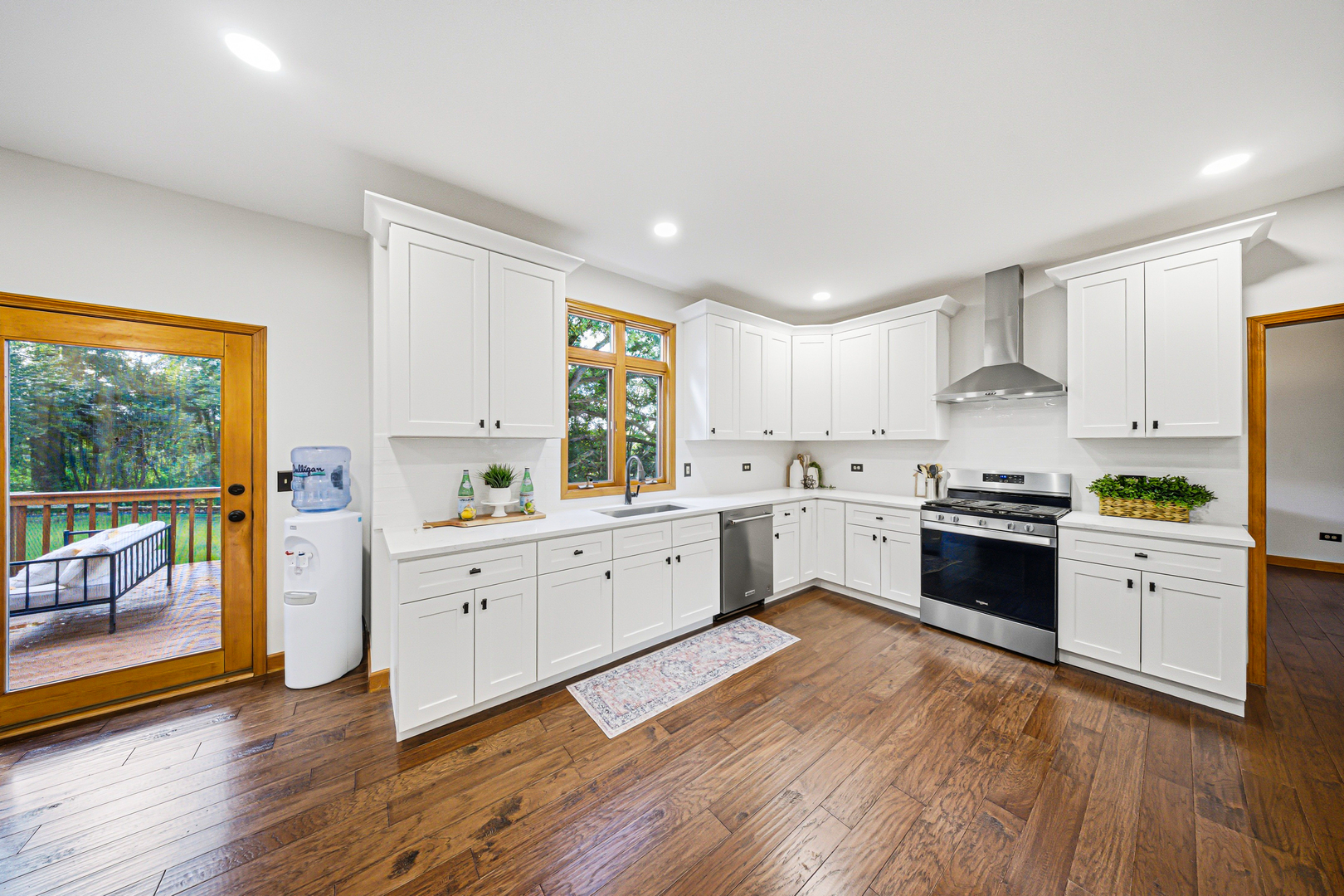 6N679 Colonel Bennett Lane St. Charles, IL 60175 - Photo 4 of 38 a large kitchen with a white cabinets and wooden floor