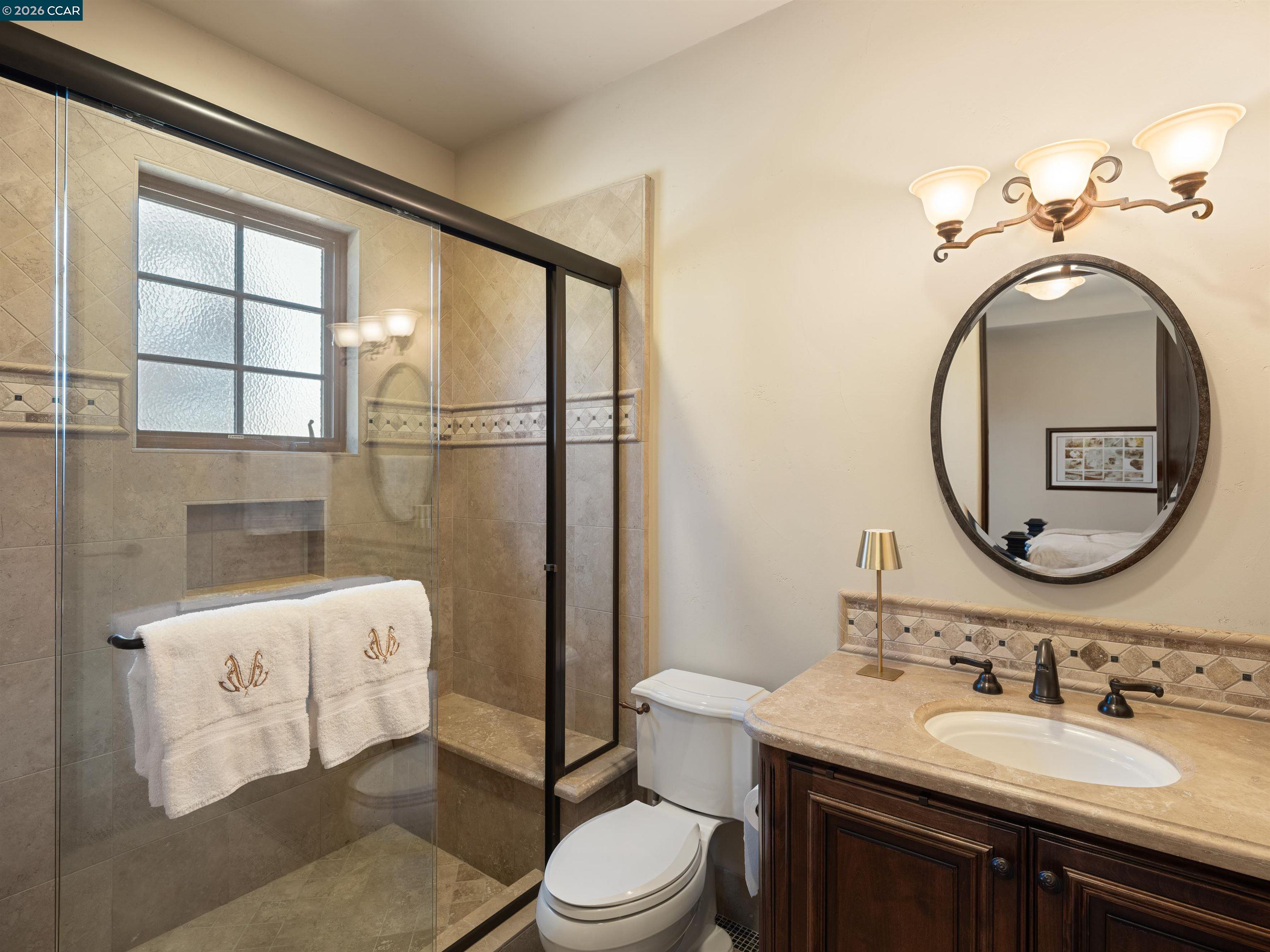 2020 Victorine Road Livermore, CA 94551 - Photo 54 of 99 a bathroom with a toilet a sink and a mirror