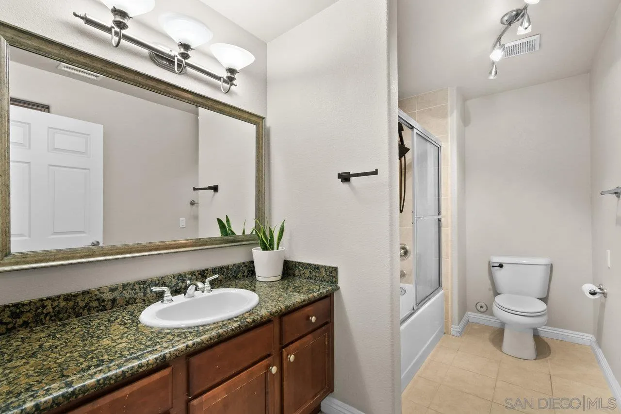 1434 Marshall Road, Unit 18 Alpine, CA 91901 - Photo 18 of 25 a spacious bathroom with a granite countertop sink and a mirror