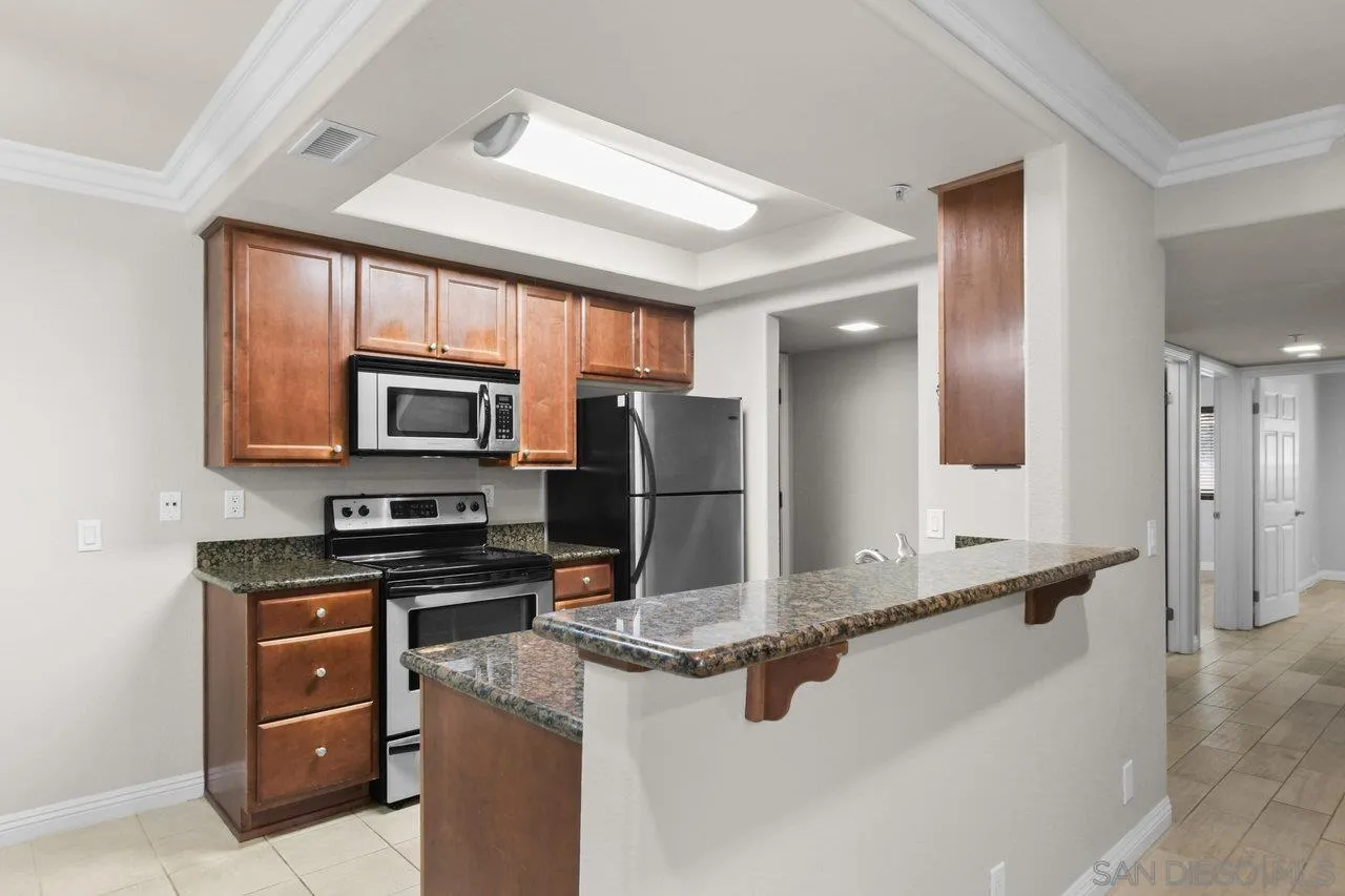 1434 Marshall Road, Unit 18 Alpine, CA 91901 - Photo 5 of 25 a kitchen with stainless steel appliances a stove sink and microwave