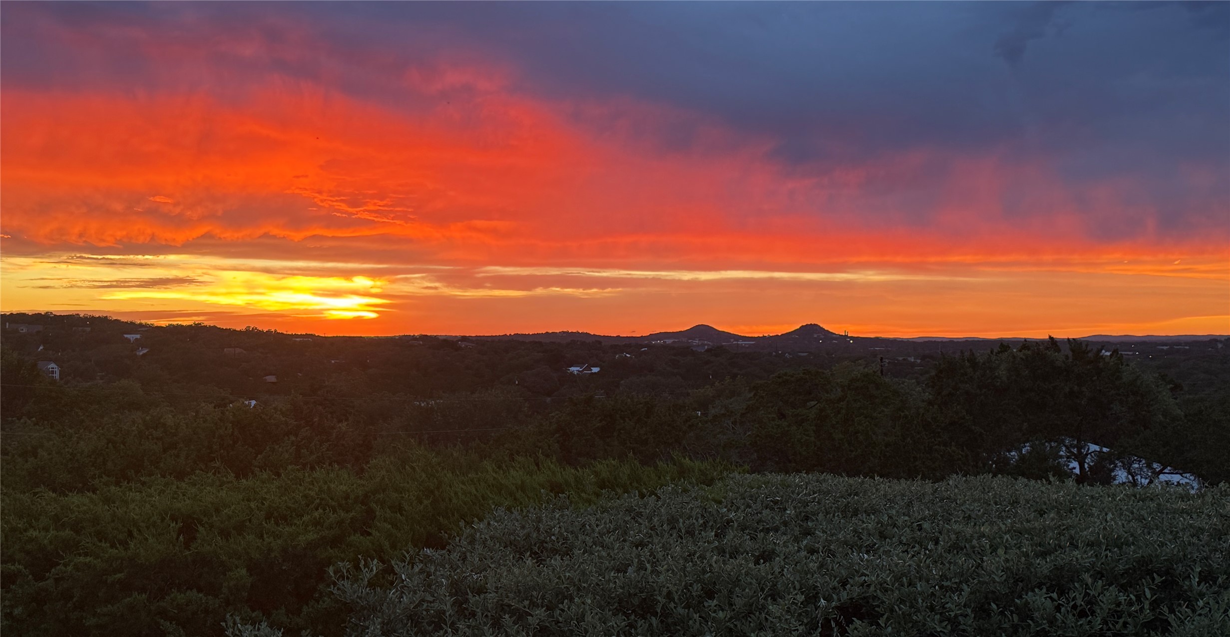 261 Barber Drive Wimberley, TX 78676 - Photo 27 of 37 Witness magnificent sunsets painting the sky over a sweeping vista of distant hills and verdant landscapes.