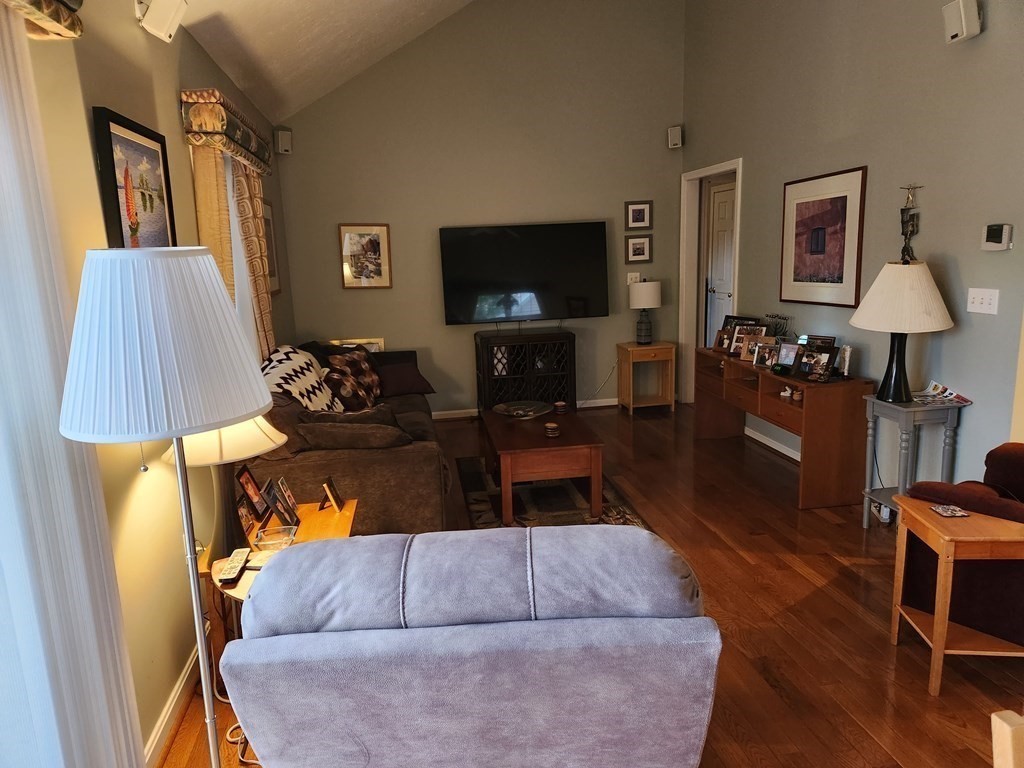 20 Augusta Way, Unit 20 Chelmsford, MA 01863 - Photo 5 of 11 a living room with furniture and a flat screen tv