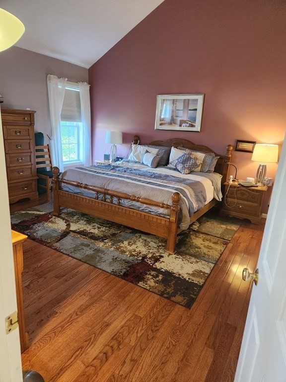 20 Augusta Way, Unit 20 Chelmsford, MA 01863 - Photo 8 of 11 a spacious bedroom with a bed a dresser and painting on the wall