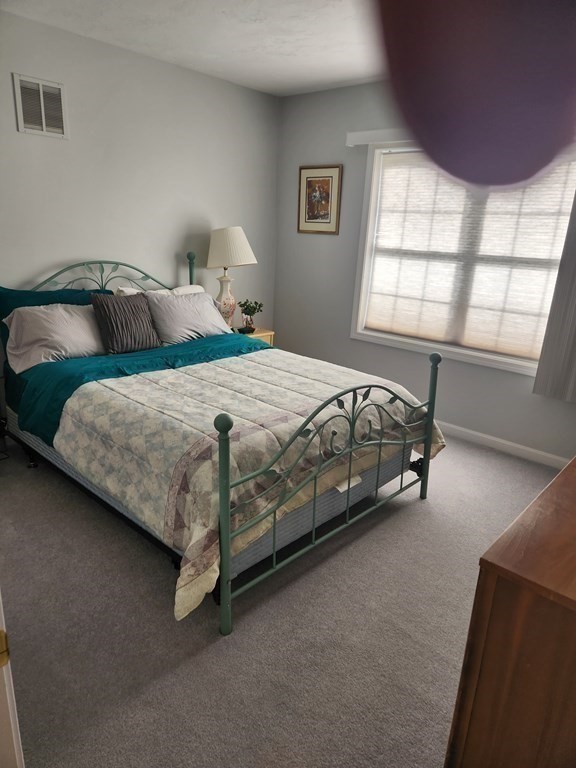 20 Augusta Way, Unit 20 Chelmsford, MA 01863 - Photo 10 of 11 a bedroom with a bed and window