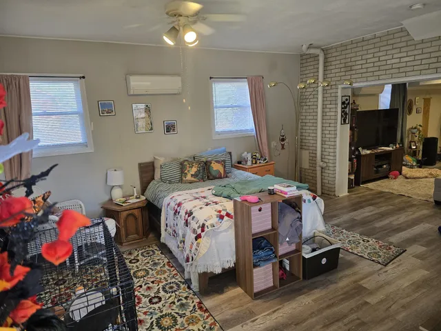 a bedroom with bed and a window