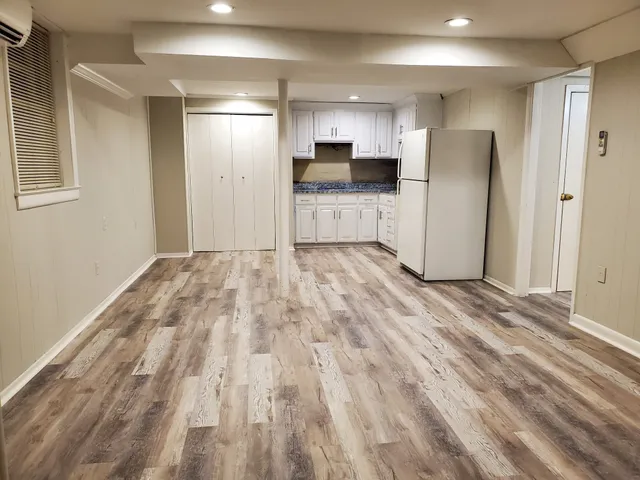 a view of a kitchen with a sink and a refrigerator