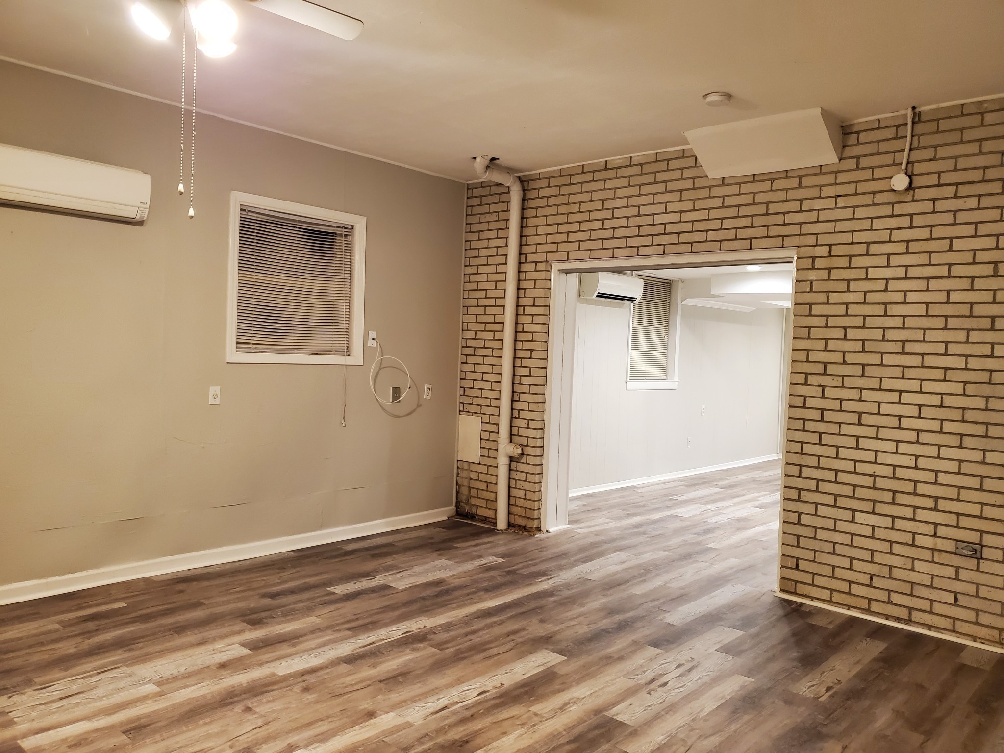 282 Le Bon Road, Unit C Nashville, TN 37211 - Photo 6 of 15 an empty room with wooden floor and windows