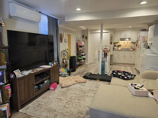 a kitchen with stainless steel appliances kitchen island granite countertop a stove refrigerator and cabinets