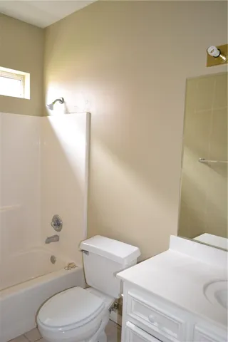 a bathroom with a toilet and tub